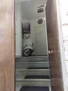 a vespa parked on the stairs of a house at B&B Sentiero Italia in Latronico