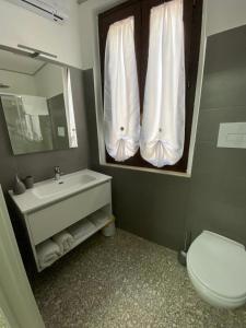 a bathroom with a sink and a toilet and a mirror at B&B Sentiero Italia in Latronico