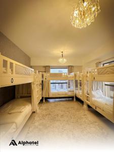a bedroom with two bunk beds and a chandelier at Alphatel Beach Hostel JBR in Dubai
