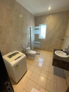 a bathroom with a toilet and a sink at تـالـيـن الـهـفـوف in Al Hofuf