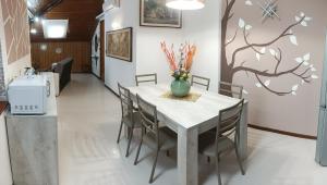 a dining room with a white table and chairs at Casa Reale in Gravina di Catania