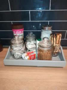 a shelf with jars of food and other items on it at The Eaves, Glastonbury High Street in Glastonbury