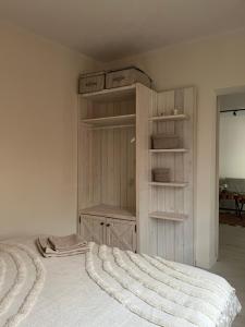 a bedroom with a bed with a book shelf at Apartamenty Aleja Jana Pawła II in Wągrowiec