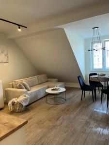a living room with a couch and a table at Apartamenty Aleja Jana Pawła II in Wągrowiec