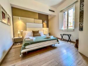 a bedroom with a large bed and a wooden floor at Santacroce Luxury Rooms in Lecce