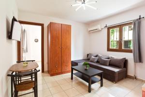 a living room with a couch and a table at Anopolh apartment 11 in Thessaloniki