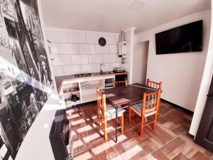 a kitchen with a table and chairs in a room at Cabañas Garcia in Algarrobo