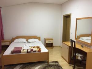 a bedroom with a bed and a mirror at Hotel Diplomat in Struga
