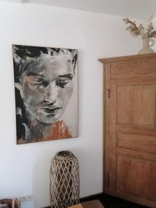 a painting of a woman on a wall in a room at Gite rural La Ferme du Semeur-Zaaiershof in Lessines