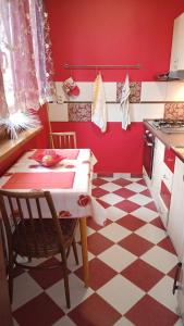a red kitchen with a table and a checkered floor at WOLF APARTMAN in Považská Bystrica
