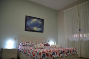 a bedroom with a bed with a tv on the wall at Best Residence **** in Termoli