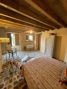 a bedroom with a large bed in a room at La Chabossière in Montbizot