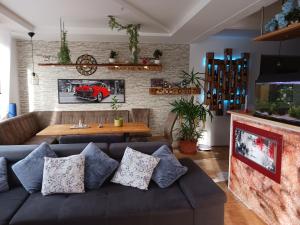 a living room with a couch and a table at Maxi's Home in Marchtrenk