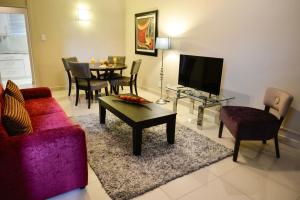 a living room with a couch and a table at Vredenburg Boutique Lodge in Vredenburg