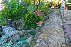 a garden with flowers and a stone path at Gure Ametza in Obanos