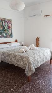 a bedroom with two beds and a blanket on a bed at City Apartment Ierapetra in Ierápetra