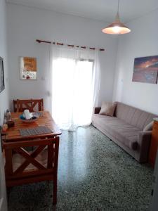 a living room with a couch and a table at City Apartment Ierapetra in Ierápetra