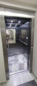 a kitchen with a stainless steel refrigerator in a room at Hotel Redentora Plaza in Sao Jose do Rio Preto