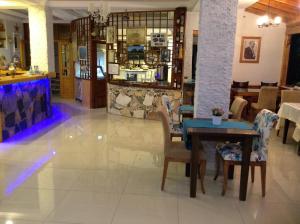a dining room with a table and chairs in a restaurant at Hotel Mola in Marmara Adasi