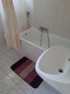 a bathroom with a tub and a toilet and a sink at Badacsonyi Panorámás magánszállás in Badacsonytomaj