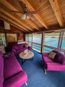 a living room with purple couches and a table at Edison in Jablanica