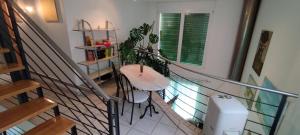 Zimmer mit einer Treppe mit einem Tisch und Pflanzen in der Unterkunft Casa Diana Locarno-Cugnasco in Locarno