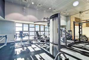a gym with several tread machines in a room at Spectacular 2 bedroom Marina sea views in Dubai