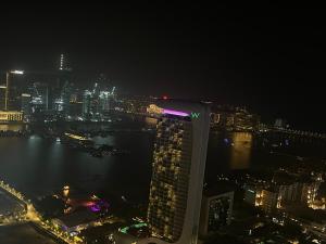 a view of a city at night with a building at Spectacular 2 bedroom Marina sea views in Dubai