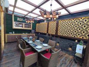 a dining room with a table and chairs at Stay @ 203 in Noida