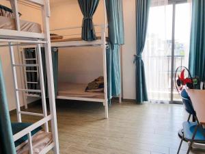 a room with two bunk beds and a window at 3Bt home in Hanoi