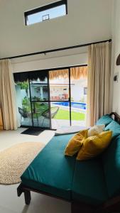 a bedroom with a green bed and a large window at Panglao Lofts in Panglao