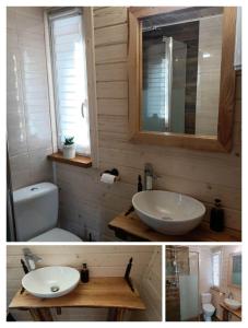 a bathroom with a sink and a toilet and a mirror at Domek Nad Stawem in Gołdap