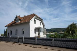a white house with a fence in front of it at Hochrhein Ferienwohnung in Albbruck