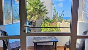 a door leading to a patio with a view of the ocean at Maison de la Lagune in Oualidia