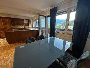a dining room with a glass table and chairs at Geräumige rustikale Tiroler Wohnung 1-8 Personen in Imst +6 photos