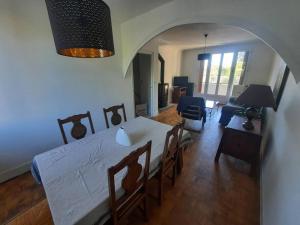 a living room with a table and a living room with a couch at Maison au Calme, prés du centre Parking Privé in Angoulême