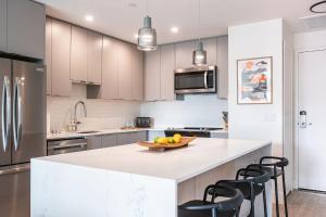 a kitchen with a counter with a bowl of fruit on it at Galena by Revelstoke Vacations in Revelstoke