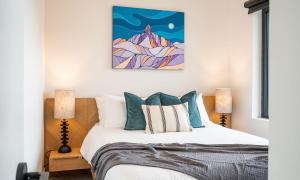 a bedroom with a bed and two lamps at Galena by Revelstoke Vacations in Revelstoke