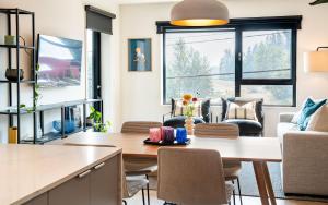 a kitchen and living room with a table and chairs at Galena by Revelstoke Vacations in Revelstoke +13 photos