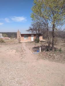 a small house in the middle of a field at La Lechuza in El Volcán