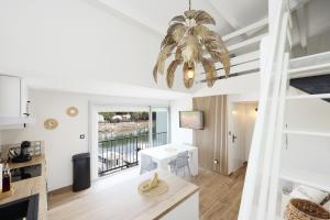 a living room with a table and a chandelier at Fare Laurent Classé 3 Étoiles Meublé de Tourisme in Saint-Cyprien-Plage