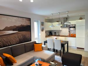 a living room and kitchen with a couch and a table at Apartament Marcin in Międzywodzie
