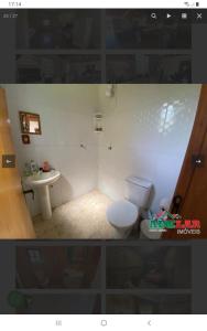 La salle de bains est pourvue de toilettes et d'un lavabo. dans l'établissement Cabana recantodosamigositapua praia dos passarinhos itapua, à Viamão