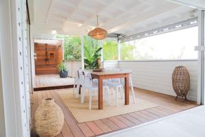 a porch with a wooden table and chairs at Kirsty's Place in Saint Barthelemy