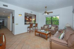 a living room with a couch and a table at Pineapple Villa 531 condo in Roatan