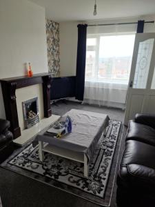 a living room with a couch and a fireplace at 3 bed house in Dewsbury West Yorkshire in Dewsbury