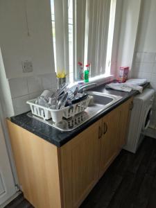 a kitchen counter with a sink and a washing machine at 3 bed house in Dewsbury West Yorkshire in Dewsbury