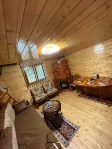 a living room with a couch and a table in a cabin at Cabana din Luncă in Bistra
