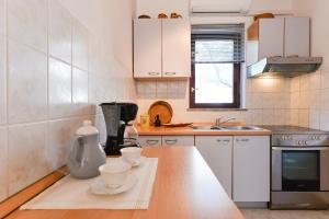 a kitchen with a counter with two cups on it at Apartments Doda in Zadar