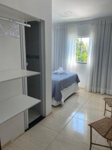 a bedroom with a bed and a window at Pousada Artelai in Angra dos Reis